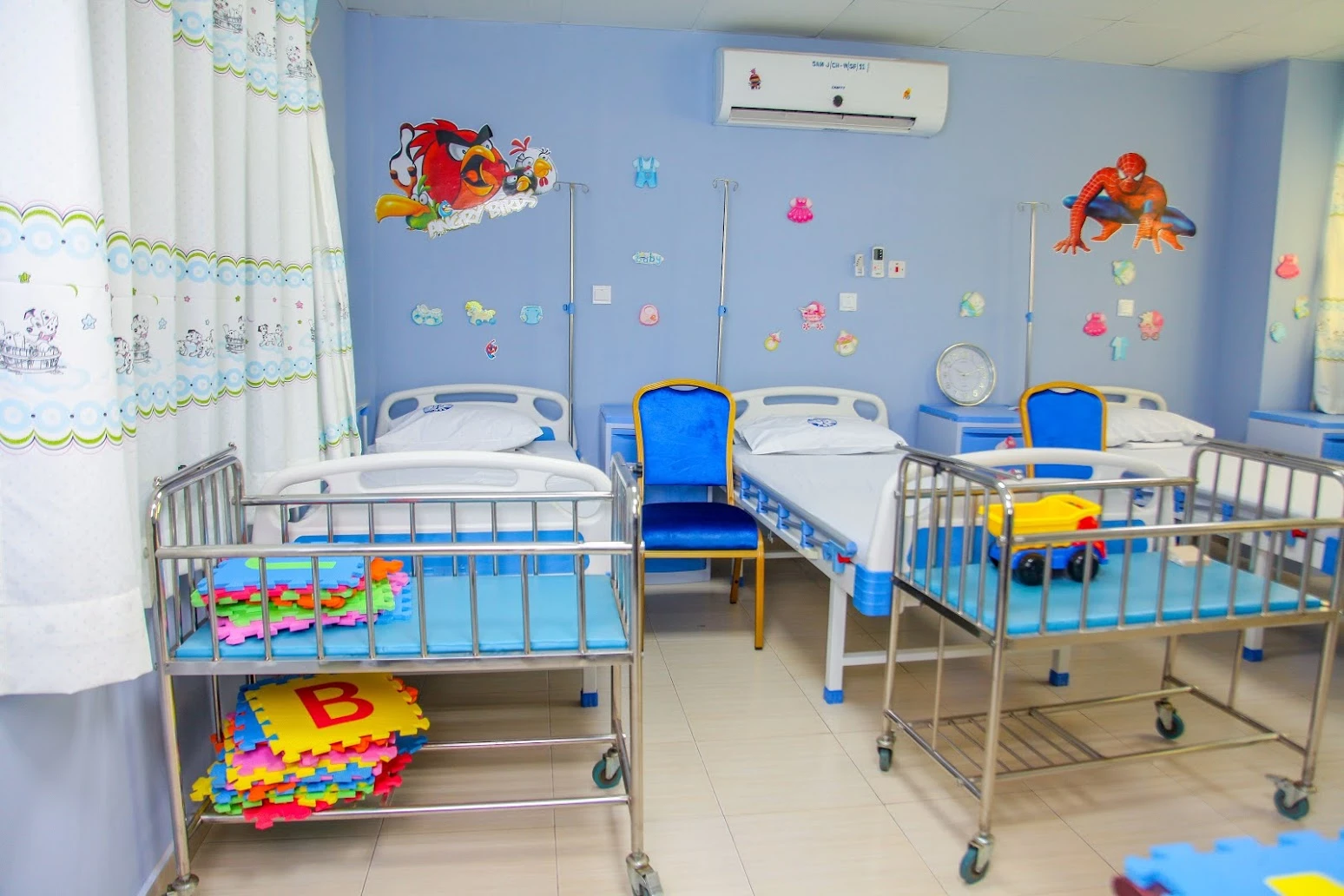 Colourful beds and cots in the unoccupied children’s ward at SamJ Hospital