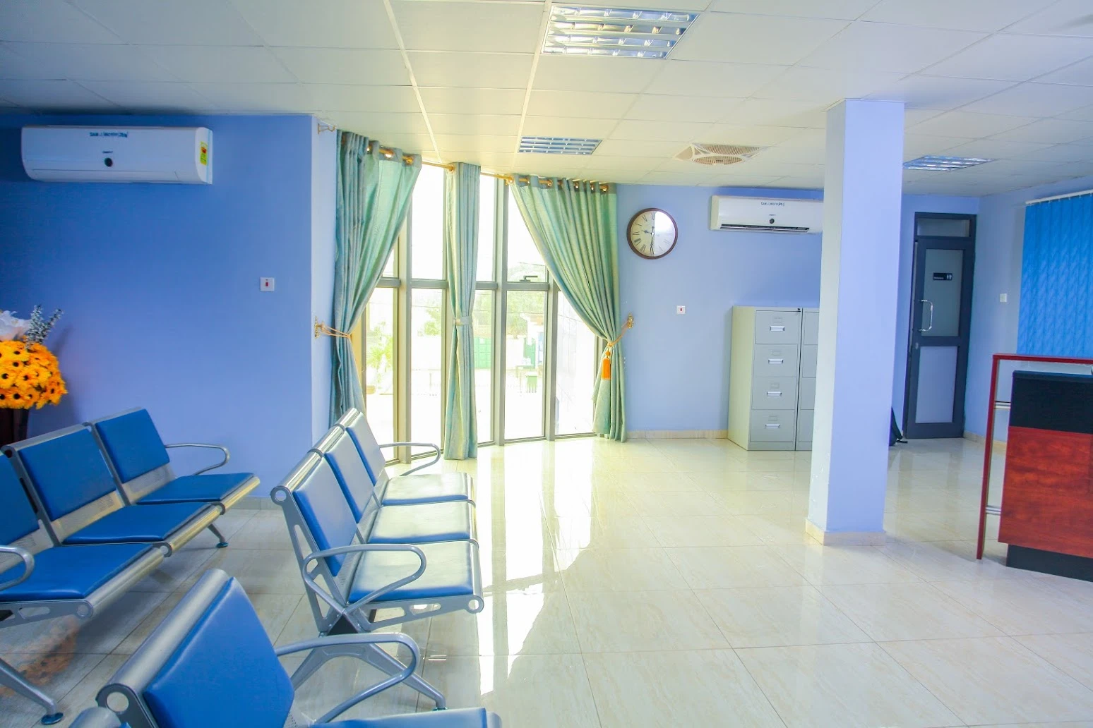 Blue seating and the reception desk at SamJ Hospital