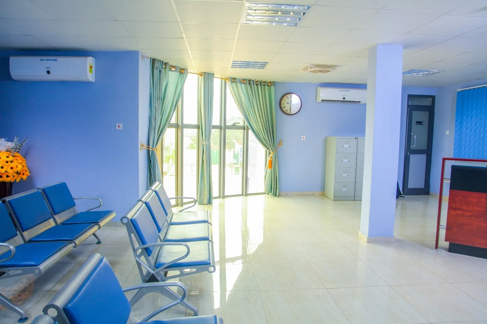 Blue seating and the reception desk at SamJ Hospital